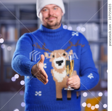 Man wearing warm blue deer sweater hold in arm 107554835