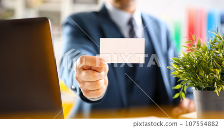 Male arm in suit give blank calling card 107554882