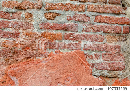 Grunge brick wall of an ancient Venetian building for your background. Italian architecture and heritage. 107555369
