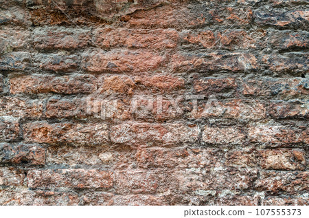 Grunge brick wall of an ancient Venetian building for your background. Italian architecture and heritage. 107555373
