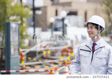A man in work clothes working at the site A man in work clothes working at the site 107555421