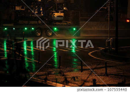 Pedestrian crossing on a rainy night Pedestrian crossing on a rainy night 107555440