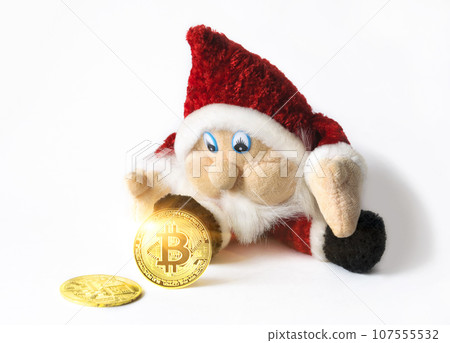 Bitcoin cryptocurrency coins and Christmas gnome toy isolated on white background. Cryptocurrency investment concept. 107555532