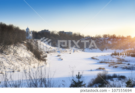 Winter cityscape with frozen river valley. Winter cityscape with frozen river valley. 107555694