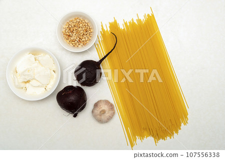 Spaghetti, beets, garlic, soft cheese and pine nuts. Spaghetti, beets, garlic, soft cheese and pine nuts. 107556338