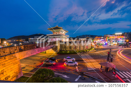 Hwaseong Fortress's Janganmun Gate at dusk. This famous historical site is a UNESCO World Heritage Site, It was almost the former capital of Korea. Hwaseong Fortress's Janganmun Gate at dusk. This famous historical site is a UNESCO World Heritage Site, It was almost the former capital of Korea. 107556357
