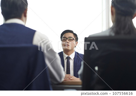 young asian business man being interviewed by two HR executives in office young asian business man being interviewed by two HR executives in office 107556616