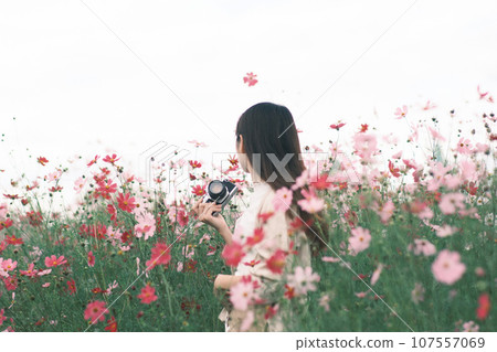A woman standing in a flower garden 107557069