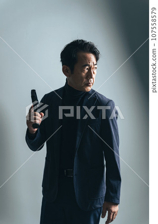 middle-aged man with a gun middle-aged man with a gun 107558579