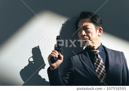 middle-aged man with a gun 107558593