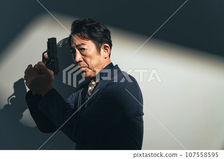 middle-aged man with a gun 107558595