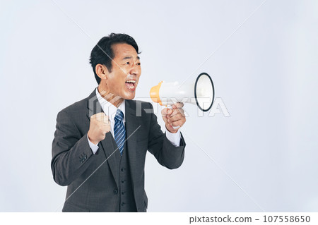 Businessman shouting with a bullhorn Businessman shouting with a bullhorn 107558650