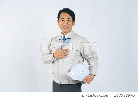 Middle-aged man in work clothes with a helmet, worker, architect 107558670