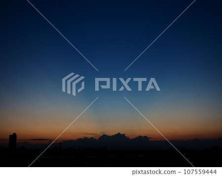 The afterglow of the sun colors the early autumn sky with beautiful rays. The afterglow of the sun colors the early autumn sky with beautiful rays. 107559444