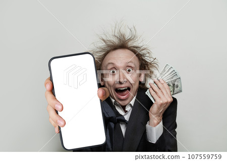 Shocked successful happy businessman holding smartphone with blank empty white screen display Shocked successful happy businessman holding smartphone with blank empty white screen display 107559759