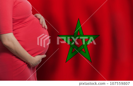 Pregnant woman belly on flag of Morocco background Pregnant woman belly on flag of Morocco background 107559807