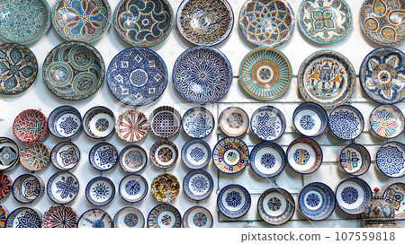 Moroccan pottery with colorful ceramics and pottery displayed outside shops in the souks, or traditional markets. Moroccan pottery with colorful ceramics and pottery displayed outside shops in the souks, or traditional markets. 107559818