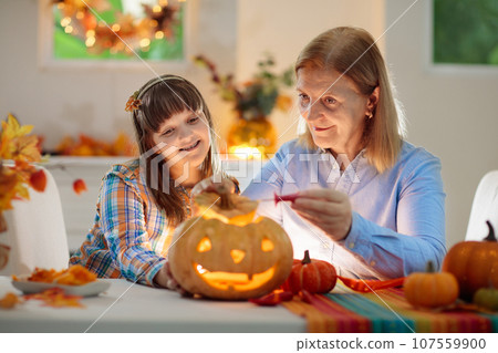 Family carving pumpkin for Halloween Family carving pumpkin for Halloween 107559900