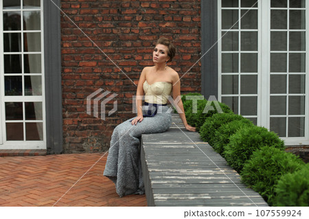 Beautiful woman wearing evening gown outdoor Beautiful woman wearing evening gown outdoor 107559924