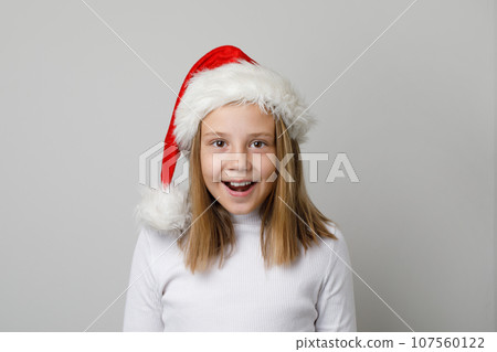 Cheerful surprised little child girl Santa having fun on white background 107560122