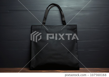Black eco cotton tote bag on a black background, Black Friday dark mockup. Sale and shopping concept. Shopper design template for advertising, branding, mockup, copyspace 107560168