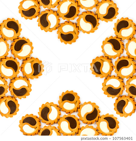 Cookies with dark and white chocolate isolated on a white . Beautiful pattern. Free space for text. Wide photo. Cookies with dark and white chocolate isolated on a white . Beautiful pattern. Free space for text. Wide photo. 107563401