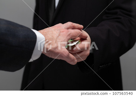 Businessmen with money, bribery concept Businessmen with money, bribery concept 107563540