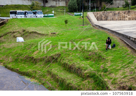 Male tourist taking photos at the famous historic Bridge of Boyaca in Colombia. The Colombian independence Battle of Boyaca took place here on August 7, 1819. 107563918