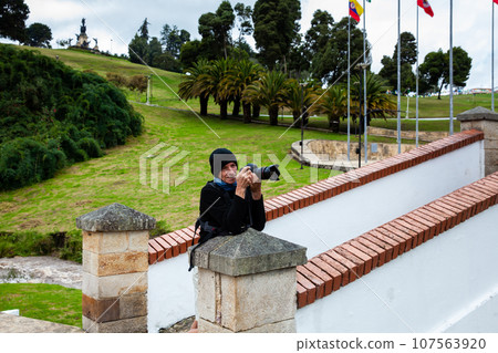 Male tourist taking photos at the famous historic Bridge of Boyaca in Colombia. The Colombian independence Battle of Boyaca took place here on August 7, 1819. Male tourist taking photos at the famous historic Bridge of Boyaca in Colombia. The Colombian independence Battle of Boyaca took place here on August 7, 1819. 107563920
