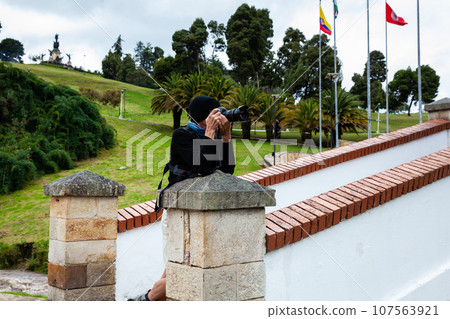 Male tourist taking photos at the famous historic Bridge of Boyaca in Colombia. The Colombian independence Battle of Boyaca took place here on August 7, 1819. Male tourist taking photos at the famous historic Bridge of Boyaca in Colombia. The Colombian independence Battle of Boyaca took place here on August 7, 1819. 107563921