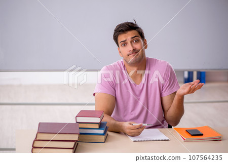 Young male student preparing for exams in the classroom 107564235