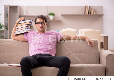 Young male student preparing for exams at home Young male student preparing for exams at home 107564243