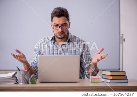 Young male student in tele-education concept 107564287