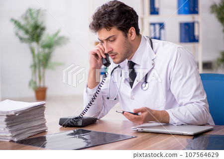 Young male doctor in telemedicine concept Young male doctor in telemedicine concept 107564629