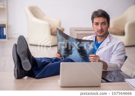 Young doctor radiologist sitting at the hospital Young doctor radiologist sitting at the hospital 107564666