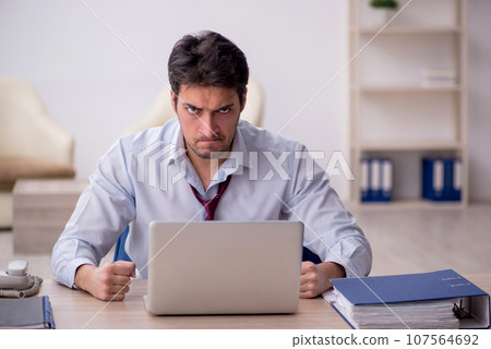 Young male employee working in the office 107564692