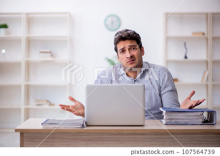 Young male employee working in the office Young male employee working in the office 107564739
