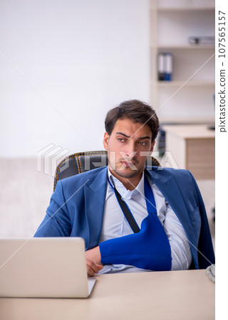 Young male employee after car accident at workplace 107565157