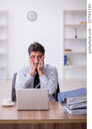 Young male employee working in the office Young male employee working in the office 107565194