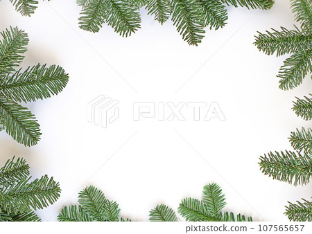 Framework of green fir twings on white paper background. Framework of green fir twings on white paper background. 107565657