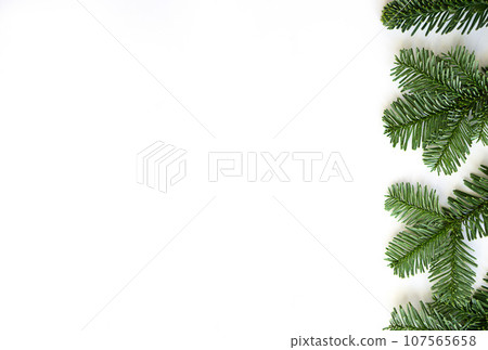 Christmas flat lay of fir branches to the right on white background with copy space. 107565658