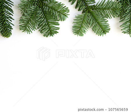 Christmas flat lay of fir branches at the top on white background with copy space. Christmas flat lay of fir branches at the top on white background with copy space. 107565659