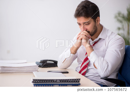 Young male employee working in the office Young male employee working in the office 107565672