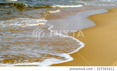 Soft sea wave on the sandy beach. Baltic Sea coast, Latvia 107565811