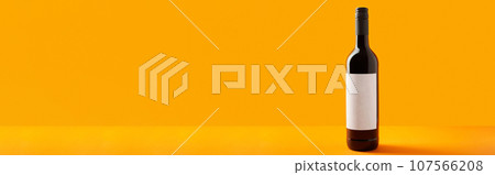 Bottle of wine on orange background. Mock up drink with place for you lable and text 107566208