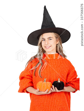 Halloween celebration concept. Portrait smiling girl in black hat, holding decorative pumpkins on white background. Halloween celebration concept. Portrait smiling girl in black hat, holding decorative pumpkins on white background. 107566876