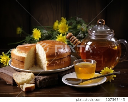 Lush fresh buns with honey and tea on the table. AI 107567445