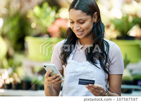 Woman phone, credit card and business owner with ecommerce, online shopping and digital payment. Outdoor, banking app and female employee with a smile with mobile connectivity on web for purchase 107567597