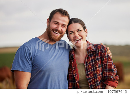 Happy, carefree, and excited farmer couple standing outdoors on cattle or livestock farmland. Portrait of relaxed lovers relaxing on organic or sustainable land smiling and enjoying nature Happy, carefree, and excited farmer couple standing outdoors on cattle or livestock farmland. Portrait of relaxed lovers relaxing on organic or sustainable land smiling and enjoying nature 107567643