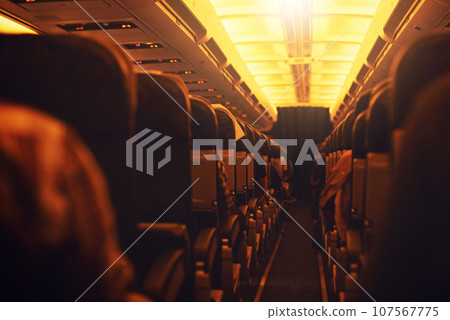 Time to jet off and explore the world. Shot of passenger seating inside an airplane. Time to jet off and explore the world. Shot of passenger seating inside an airplane. 107567775